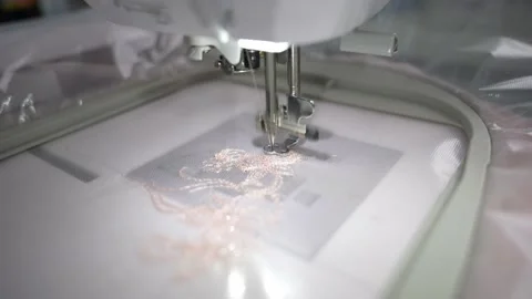The sewing machine embroiders a pattern on the fabric Stock Footage 232868645