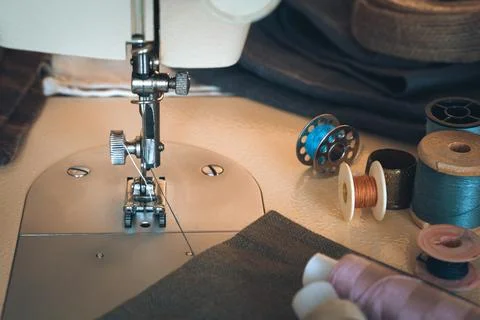 Sewing machine, fabrics and thread. The side view is horizontal. Stock Photos