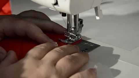 The sewing machine is filled with red sewing thread and red cloth. Stock Footage 122920563