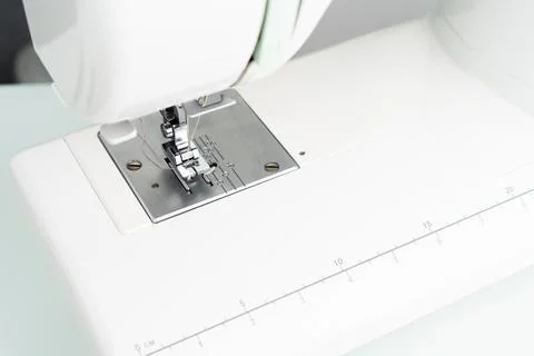 Sewing machine foot close-up, light photo and a place for text on the right Stock Photos