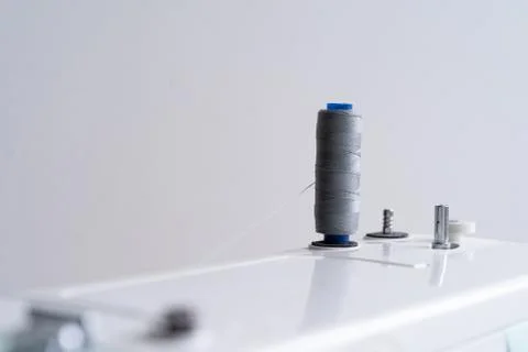 Sewing machine with gray spool of sewing thread, sewing accessories Stock Photos