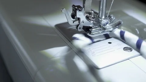 Sewing machine, hands preparing a white mask to protect themselves from Covid-19 Stock Footage 127041330
