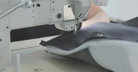 Sewing machine makes a seam on fabric. Sewing process. Industrial sewing machine Video stock 330441229