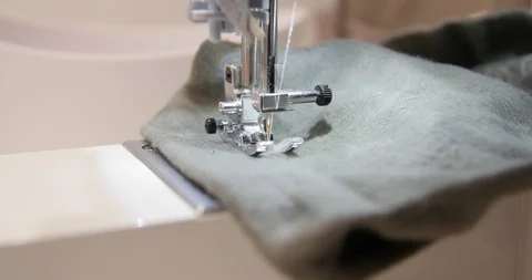 Sewing Machine making automated embroidery on grey fabric. soft wool based Stock Footage 120073521