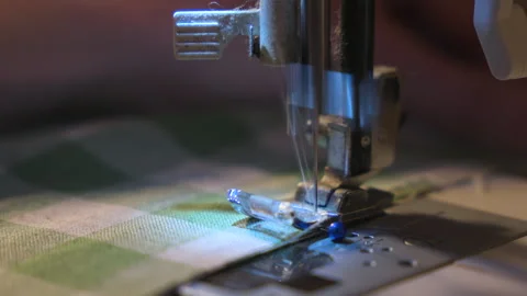 Sewing machine making home made craft. Close-up of green and white fabric in Stock Footage 335402917