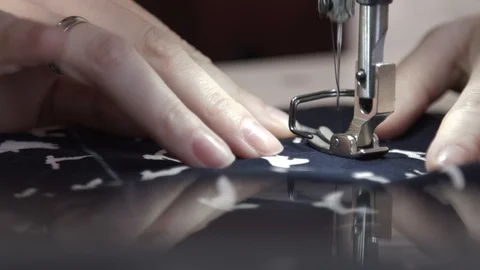 A sewing machine in motion. Close-up of sewing machine needle rapidly moves up Stock Footage 100843633
