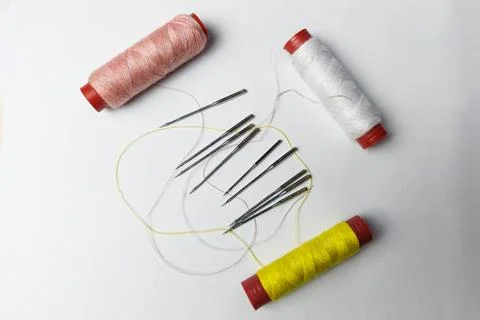 Sewing machine needle and thread on white background Stock Photos