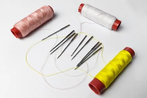 Sewing machine needle and thread on white background Stock Photos