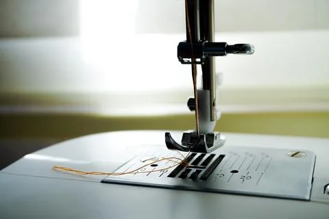 Sewing machine needle bobbin and stitch settings details close up view 写真素材
