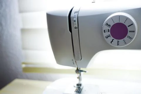Sewing machine needle bobbin and stitch settings details close up view 写真素材