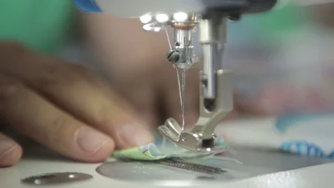 Sewing machine, needle - close-up at work. female hands in a factory Stock Footage 114989931