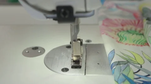 Sewing machine, needle - close-up at work. female hands in a factory Stock Footage 114989942