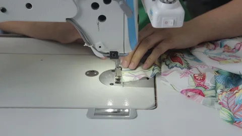 Sewing machine, needle - close-up at work. female hands in a factory Stock Footage 114989951