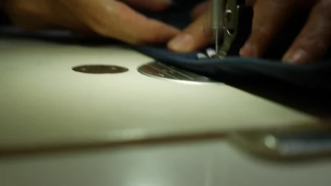 A sewing machine needle creates stitches across fabric near the body of the mach Stock Footage 340150204