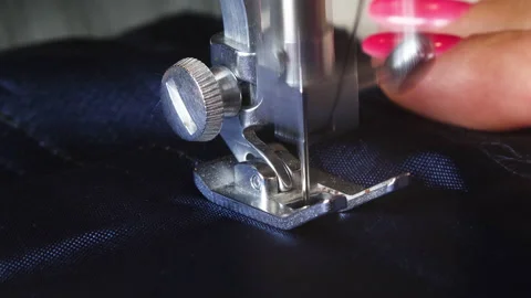 Sewing machine needle in motion. Close-up macro  of sewing on machine Stock Footage 136972813