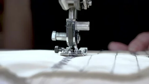 Sewing machine needle in motion. Close-up of a sewing machine needle moving up Video stock 141355641