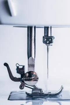 Sewing machine needle mounted on the machine. Stock Photos