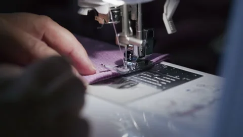 Sewing machine needle plunging into purple fabric close-up Stock Footage 344382106