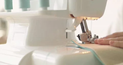 Sewing machine needle quickly moves up and down. Designer sews fabric in Stock Footage 202515221