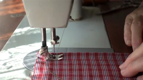 A sewing machine needle scribbles a fabric in slow motion. Stock Footage 129910781