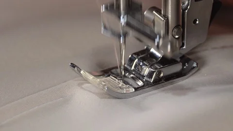 Sewing machine needle slow motion, close up. Sewing fabric by sewing machine Stock Footage 129570414