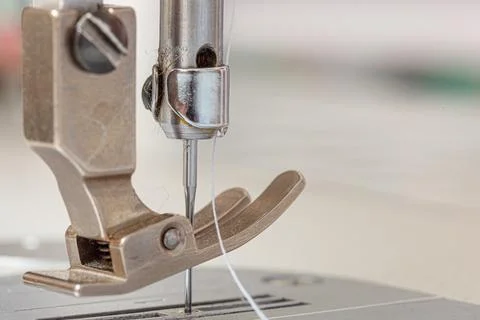 Sewing machine needle with thread and fabric Stock Photos