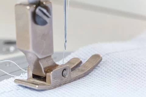 Sewing machine needle with thread and fabric Stock Photos