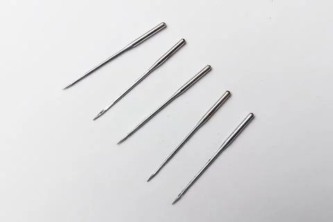 Sewing Machine Needles Lined Up on a White Background Stock Photos