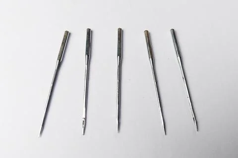 Sewing Machine Needles Lined Up on a White Background Stock Photos