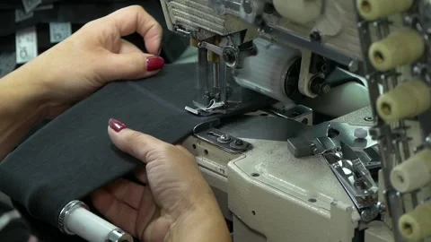 Sewing machine in operation. 2 Shots. Stockbeeldmateriaal 335294286