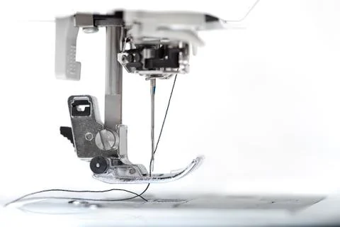Sewing machine part with needle closeup on white background Stock Photos