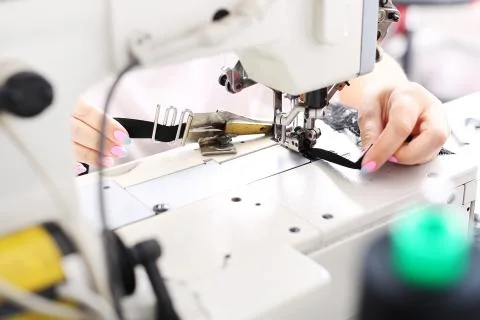 Sewing on a machine. Stock Photos