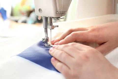 Sewing on a machine. Stock Photos