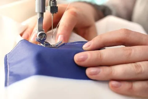 Sewing on a machine. Stock Photos