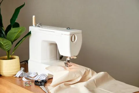 Sewing machine with piece of fabric on table. Stock Photos
