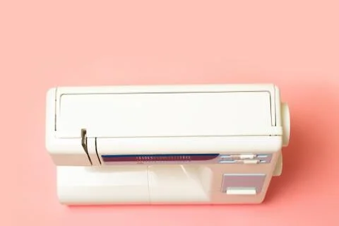 Sewing machine on pink table. View from above 스톡 사진