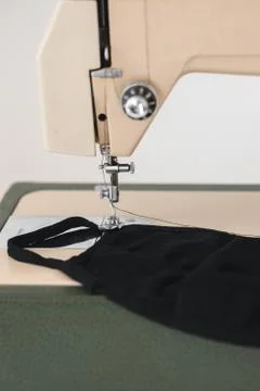 Sewing machine the process of sewing a protective medical mask workplace Stock Photos