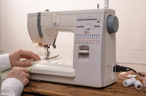 Sewing machine ready for work with fabric positioned under needle. Stock Photos