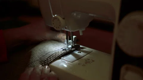 On a sewing machine sew clothes close-up. Dressmaker sews fabric. Stock-Footage 131064392