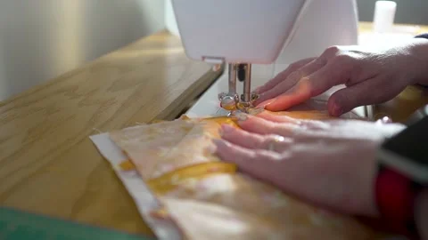 Sewing machine in slow motion stitching a homemade potholder together - Stock Footage 167628349