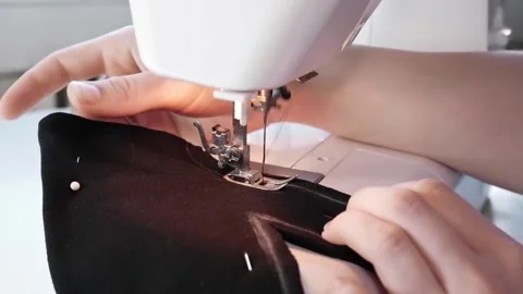 Sewing machine stitching black fleece gloves. Close up of sewing needle. Stock Footage 165280152