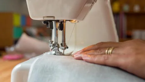 Sewing machine stitching fabic Stock Photos