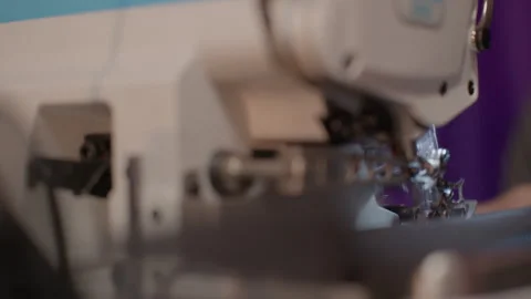 Sewing machine stitching fabric creating new fashion apparel Stock Footage 342199906