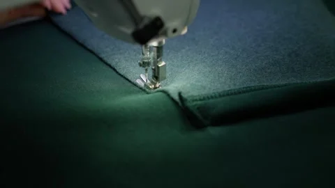 Sewing machine stitching fabric in textile workshop. Clothing detailing concept. Stock-Footage 287016919