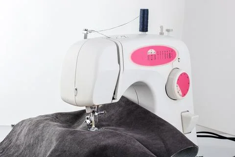 Sewing machine, stitching fabrics, needle in a round plan Stock Photos