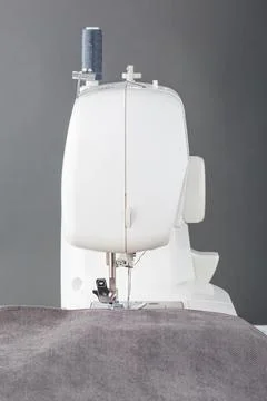 Sewing machine, stitching fabrics, needle in a round plan Stock Photos