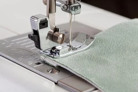 Sewing machine, stitching fabrics, needle in a round plan Stock Photos