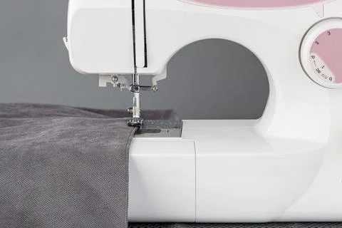 Sewing machine, stitching fabrics, needle in a round plan Stock Photos
