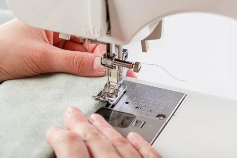 Sewing machine, stitching fabrics, needle in a round plan Stock Photos