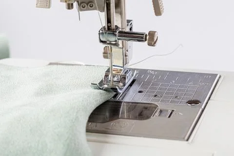 Sewing machine, stitching fabrics, needle in a round plan Stock Photos